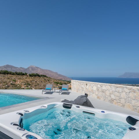 Sink into your bubbling hot tub to watch the sunset from the beach seat in the house
