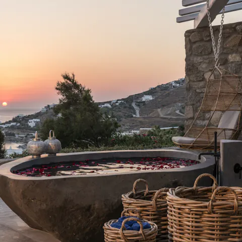 Soak in the outdoor stone bath as the sun sets