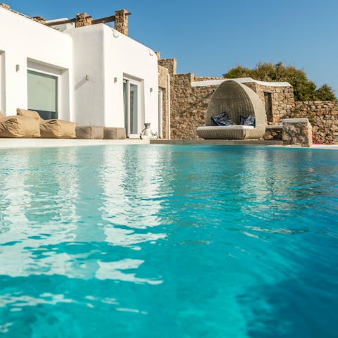 Swim laps in the turquoise waters of the private pool