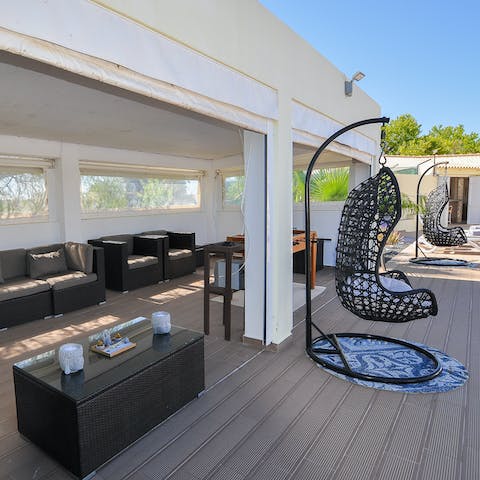 Find a comfortable seat in the shade of the covered terrace with a glass of wine