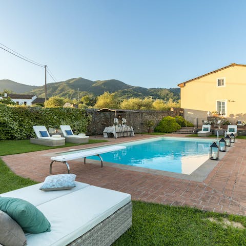 Relax on the day beds around the swimming pool with a glass of Italian wine in hand