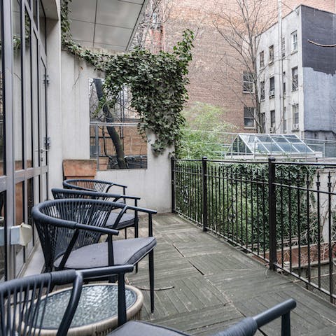 Sip a Manhattan cocktail out on the balcony