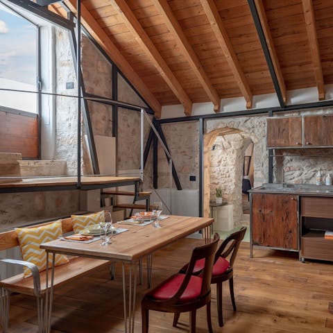 Dine together in the living space, complete with authentic stone walls