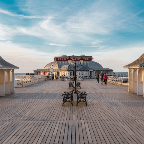 Take a stroll along Cromer's historic pier, a twenty-five-minute drive away