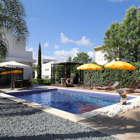 Sunbathe on a lounger or bob about in the communal pool