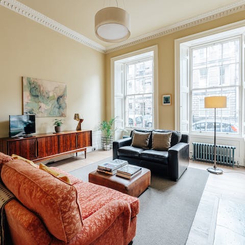 Relax on the plush sofas in the bright living room, with its original sash windows