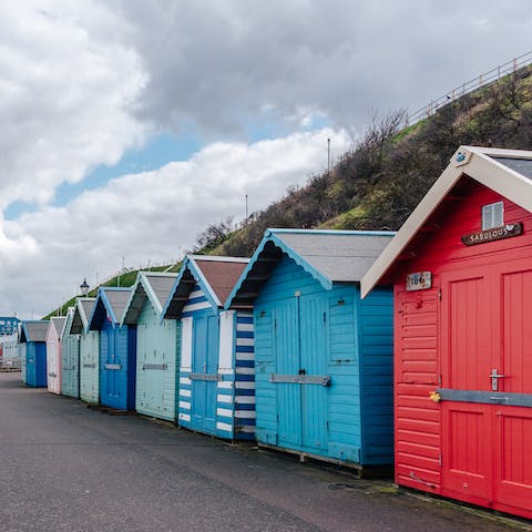 Tuck into fish and chips near the brightly coloured beach huts