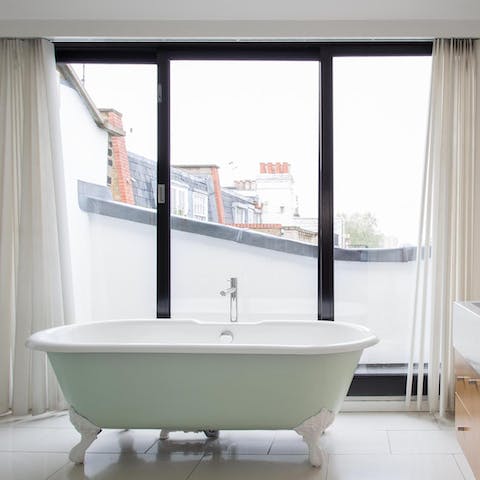 Relax and unwind in the rolltop bathtub in the ensuite master bathroom