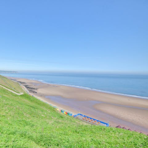 Sink your toes in the sand at Whitby Beach, a seven-minute walk away
