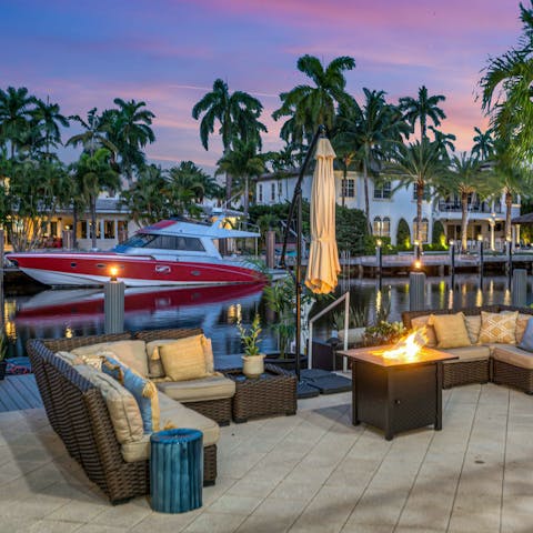 Enjoy the waterfront views as you gather around the fire pit with drinks