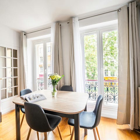 Sip wine beside the floor-to-ceiling windows of this elegant apartment