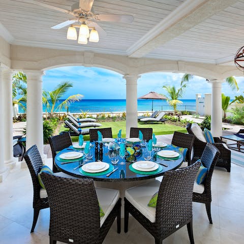 Dine in the shade of the terrace to the sound of the waves beyond