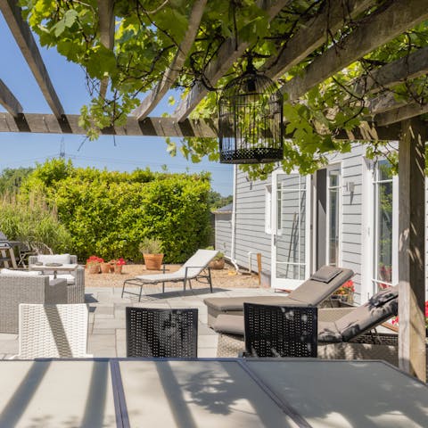 Sunbathe in the secluded south-facing garden or dine under the shade of the vine