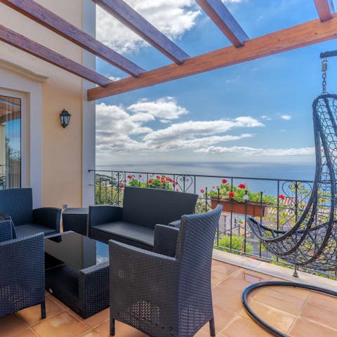 Gaze out at stunning views of the ocean from the egg chair or lounge furniture on the terrace