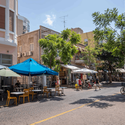 Explore the food stalls and street cafés of Nachalat Binyamin Market just down the street