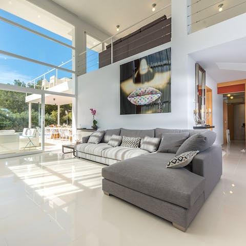 Relax in the cool and bright living room with its marble flooring