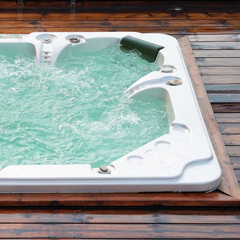 Watch the sunset with a glass of wine in the shared hot tub