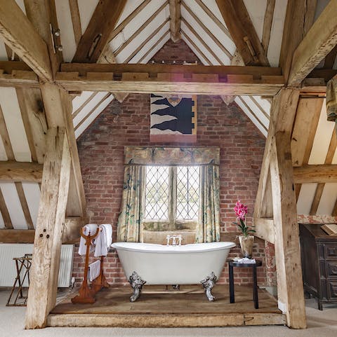 Soak in the classic claw foot tub set under the original wooden beam ceiling