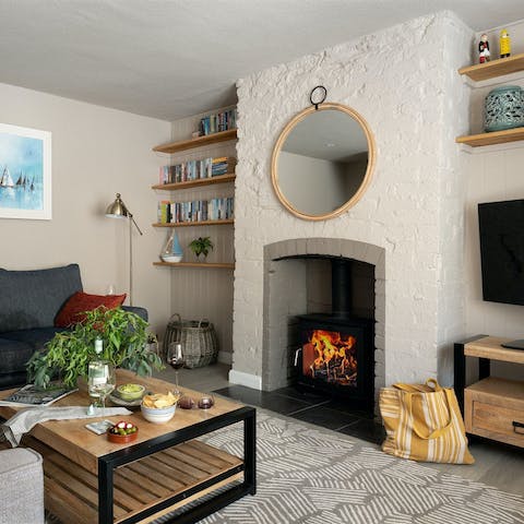 Cosy up in the stylish living room, warmed by a log burner
