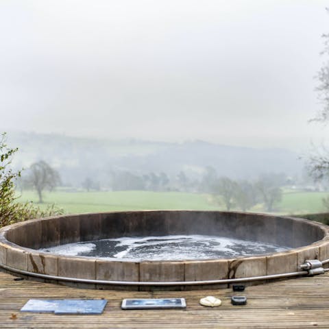 Feel your cares melt away in the private hot tub overlooking the valley