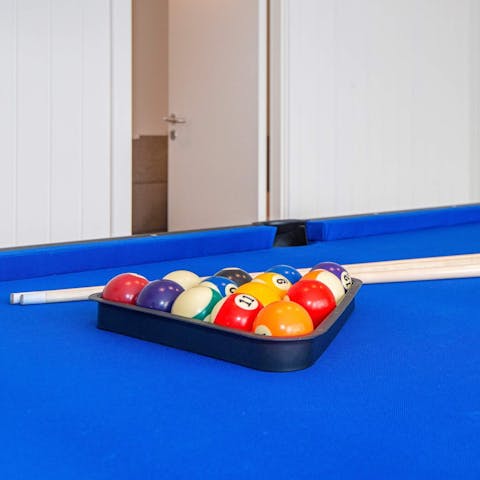 Challenge your family to a friendly snooker tournament in the games room