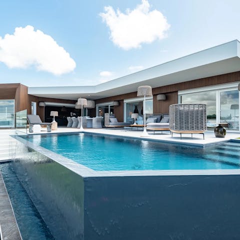 Slip into your swimwear and cool off in the infinity pool