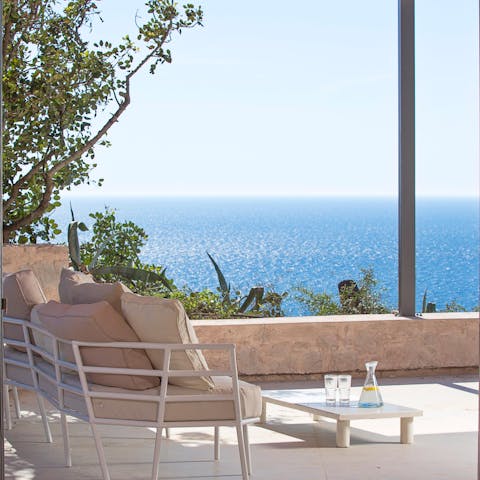 Admire the gorgeous sea views on the terrace, a glass of wine in hand