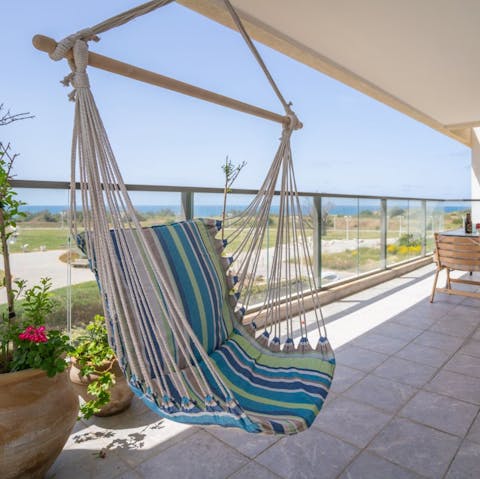 Retreat to the balcony and swing back & forth on the hammock chair to soak up the rays in style