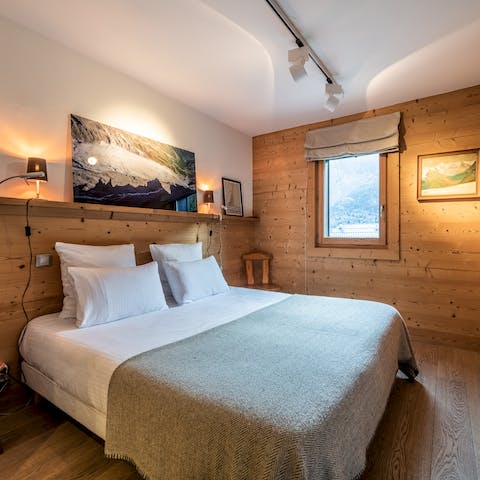 Sleep in chalet-chic bedrooms lined in warm wood