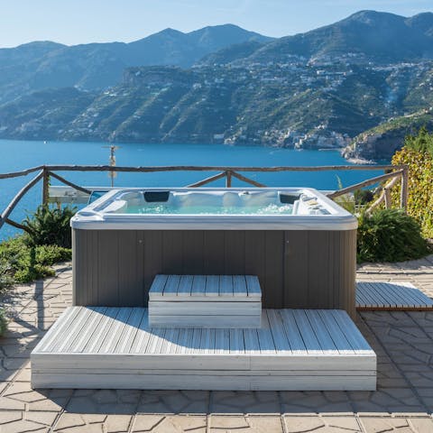 Relax in the private hot tub with its spectacular blue backdrop