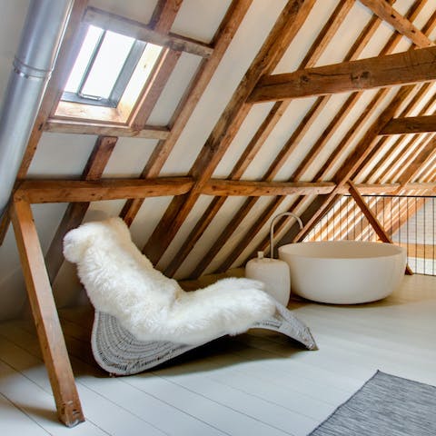 Soak sore muscles in the freestanding bowl-shaped bathtub after a morning stroll