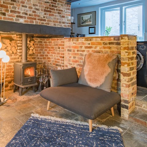 Relax on the cosy armchair, catching up on your current read, while the fireplace warms you up
