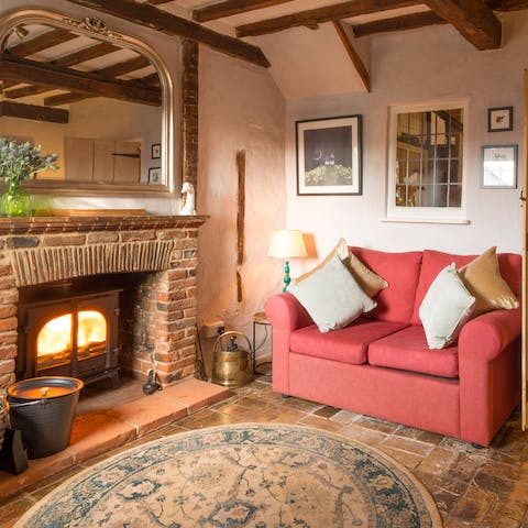 Get warm and cosy in front of the wood-burner in the snug living room 