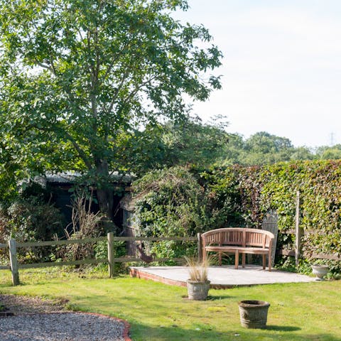 Appreciate the serenity of the Suffolk countryside in the sunny garden