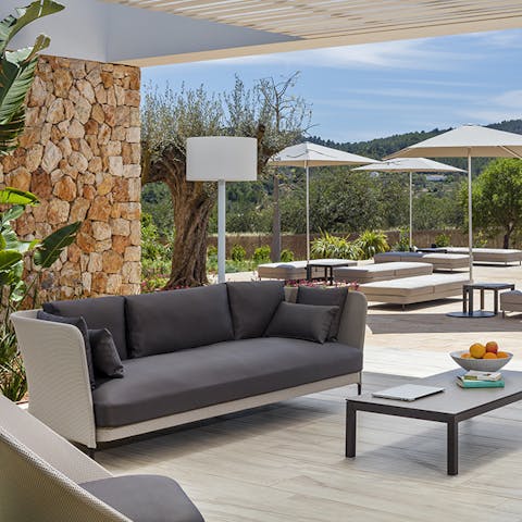 Relax on the shaded terrace area after a day of Santa Eulalia Beach