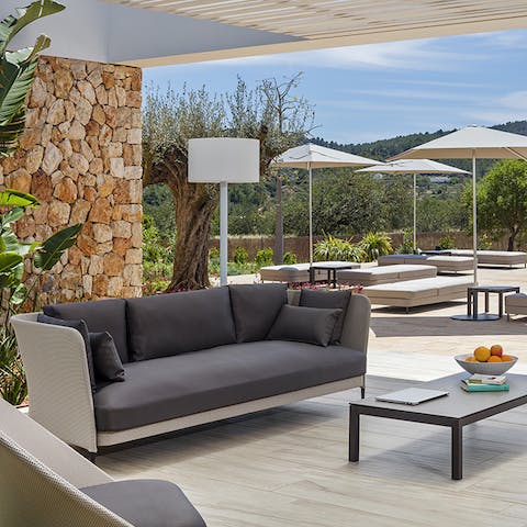 Relax on the shaded terrace area after a day of Santa Eulalia Beach