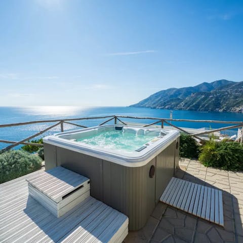 Relax and unwind in the hot tub with its magnificent sea views