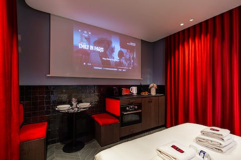 Watch movies in bed on the home's cinema screen