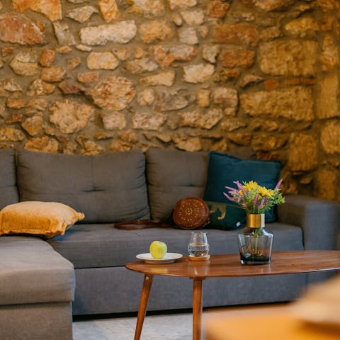 Enjoy drinks in the living area surrounded by exposed brick
