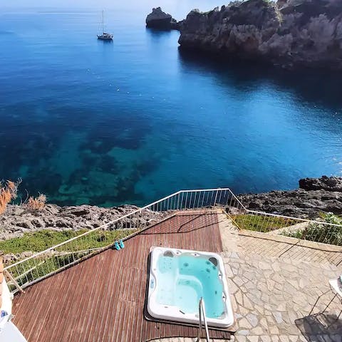 Enjoy a glass of Cava in the hot tub with its glorious sea vistas
