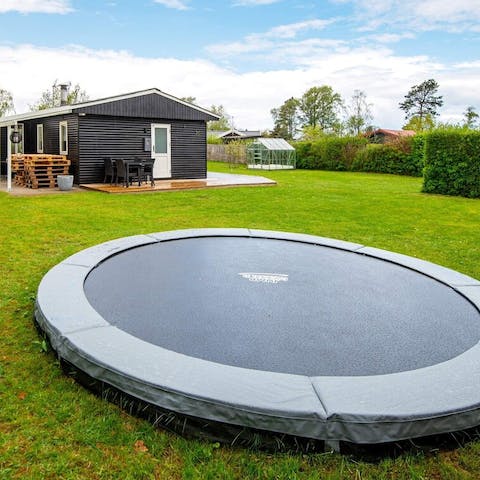 Let the kids have fun on the trampoline in the garden