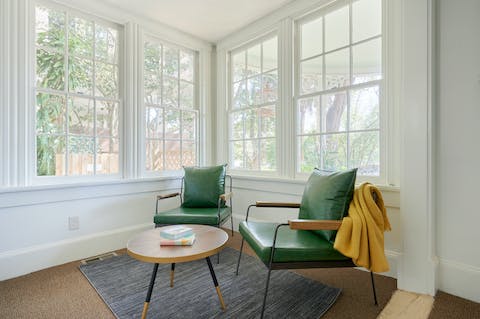 Catch up on some reading in the room's light-filled seating area