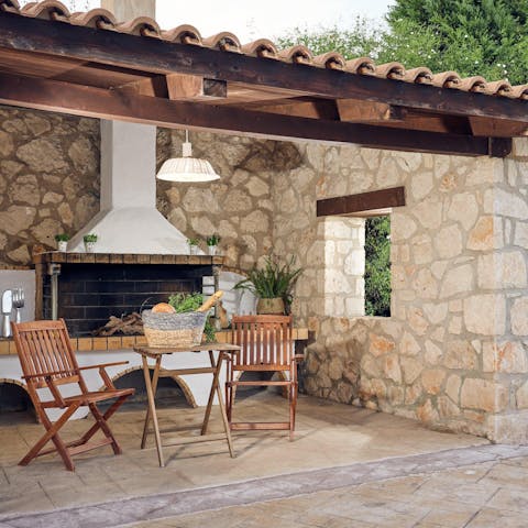 Fire up the barbecue for a grilled feast under the shade of the pergola
