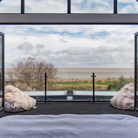 Wake up to the panoramic views of the sea from the luxurious master bedroom 