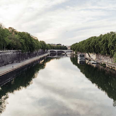 Take a morning stroll along the Tiber River, just five minutes from your door