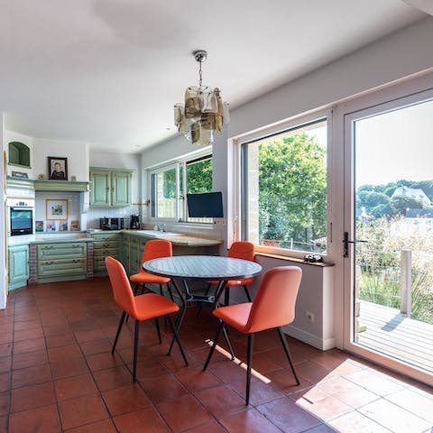 Carry food from stove to table in the open kitchen and dining space