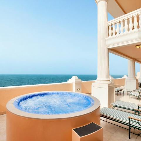 Keep your eye on the Arabian Gulf as you relax in the private hot tub