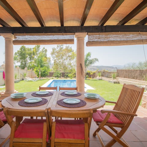 Dine alfresco with views out to the garden and the mountains beyond