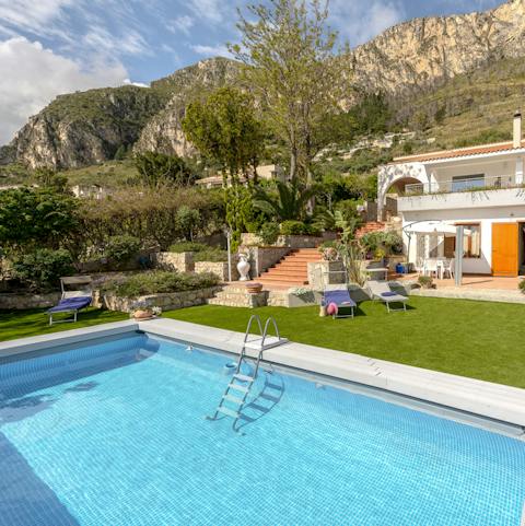 Swim laps in the huge pool as the Sicilian mountains loom around you
