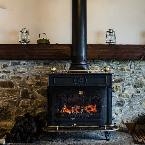 Get cosy by the wood-burning fireplace as the sun sets